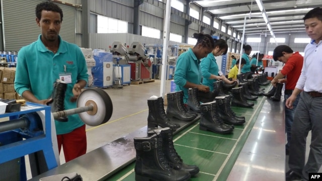 People work on the assembly line at Huajian shoe factory in Dukem, Ethiopia, April 19, 2012.
