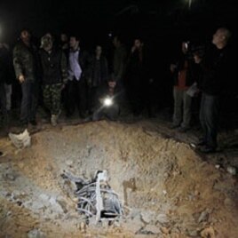 A crater, which the Libyan government said was caused by coalition air strikes, is seen at an area in Bab al-Aziziyah compound in Tripoli, April 23, 2011 (picture taken on guided government)