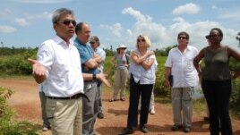 Youk Chhang, Elizabeth Becker and Michael ABRAMOWITZ, USHMM Director and his delegations at a B52 bomb pond near the Chinese airport, Kampong Chhnang province. Oct 24, 2012. Photo by Nhean Socheat.