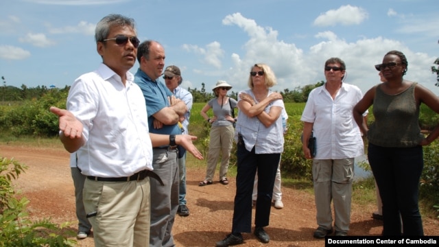 Youk Chhang, Elizabeth Becker and Michael ABRAMOWITZ, USHMM Director and his delegations at a B52 bomb pond near the Chinese airport, Kampong Chhnang province. Oct 24, 2012. Photo by Nhean Socheat.