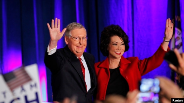 FILE - U.S. Senator Mitch McConnell waves to supporters with his wife, former United States Secretary of Labor Elaine Chao, at a rally in Louisville, Kentucky, November 4, 2014.