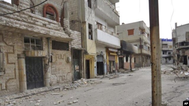 Damaged houses seen at Karm al-Zeitoun near Homs, March 13, 2012. 