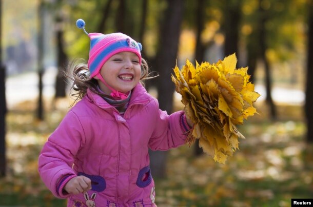 Kids all over the world like to play in the fallen leaves of autumn.