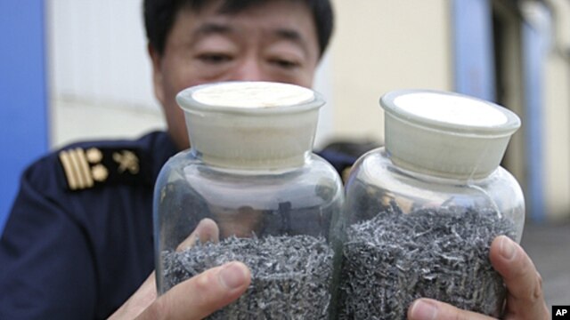 A Chinese border policeman displays confiscated vanadium bound for North Korea at a checkpoint in Dandong, Liaoning province. Chinese border police have seized 70 kg (154 lb) of the strategic metal vanadium bound for North Korea, foiling an attempt to smu