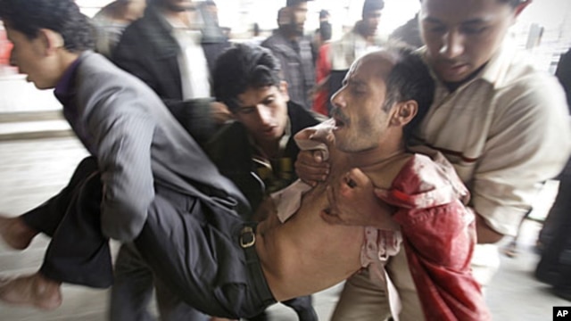 A wounded protestor is carried from the site of clashes with security forces in Sana'a, Yemen, November 24, 2011.