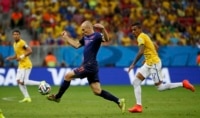 Arjen Robben of the Netherlands controls the ball ahead of Brazil's Luiz Gustavo during the third-place playoff at the Brasilia national stadium.