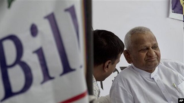 Indian social activist Anna Hazare, right, looks on during his hunger strike against corruption, in New Delhi, India, April 7, 2011