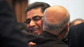 Syrian communications executive Ghassan Hitto (L), is congratulated late on March 18, 2013 in Istanbul after Syria's main opposition National Council elected him as prime minister.