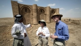 Laurie Rush and colleague Brian Rose at the ancient city of Uruk in Iraq, talking with Mr. Altubi, head of the family that protects the site. (Courtesy Laurie Rush)