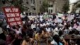 Kenyan  demonstrators,  some chained to each other, gather near the gate of parliament  in Nairobi, Kenya, May 14, 2013.