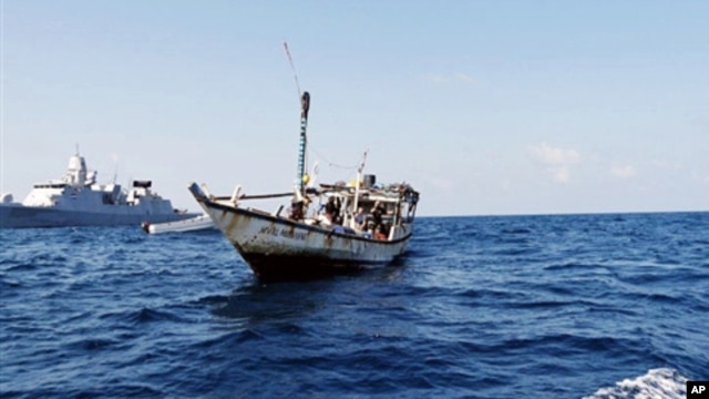 FILE - A handout picture received from The Netherlands Ministry of Defence shows a boat containing alleged Somali pirates being apprehended by Netherlands warship Evertsen.