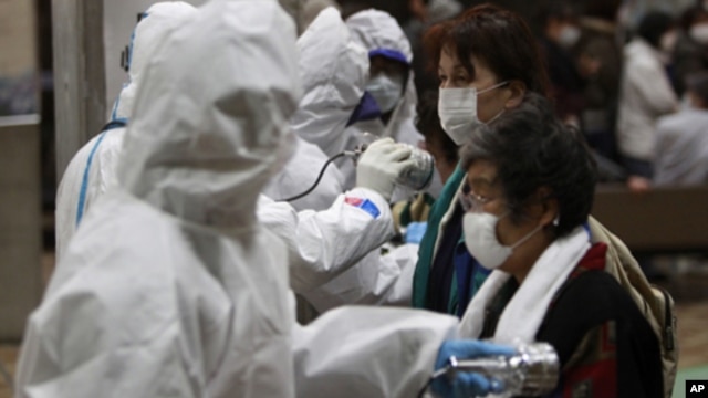 Evacuees are screened for radiation contamination at a testing center Tuesday, March 15, 2011, in Koriyama city, Fukushima Prefecture, northern Japan, four days after a massive earthquake and tsunami struck the country's north east coast.