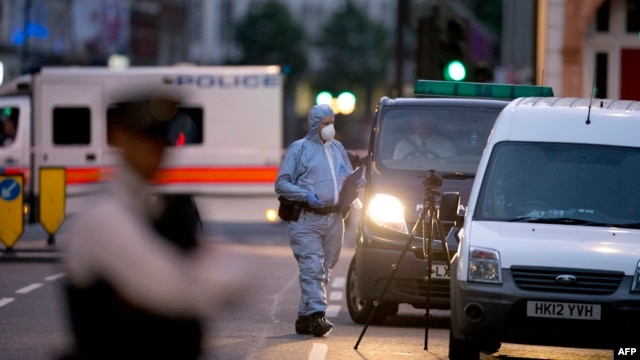 A police forensic officer works in Russell Square in London early on August 4, 2016, after a knife attack in which a woman in her 60s was killed.