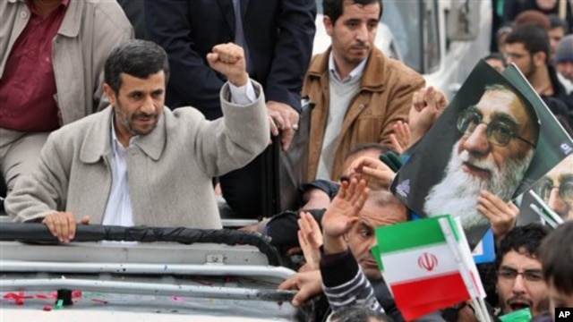 Iranian President Mahmoud Ahmadinejad, clenches his fist from his car, as he attends a rally marking the 32nd anniversary of 1979 Islamic Revolution, Feb 11, 2011