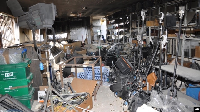 In this photo released by the Syrian official news agency, SANA, a damaged equipment storage room of the Ikhbariya TV station is seen after it was attacked by gunmen in the town of Drousha, south of Damascus, June 27, 2012. 
