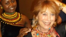 Jacqueline Kamsu tries one of her handmade necklaces on an American customer. (Kamsu)