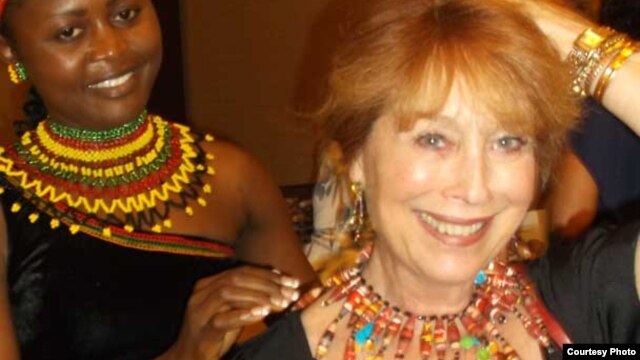 Jacqueline Kamsu tries one of her handmade necklaces on an American customer. (Kamsu)