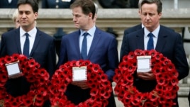Britain's Prime Minister David Cameron (R) stands with former former Liberal Democrat leader Nick Clegg (C) and former Labour Party leader Ed Miliband, as they line up to pay tribute at the Cenotaph during a Victory in Europe (VE) day ceremony in central