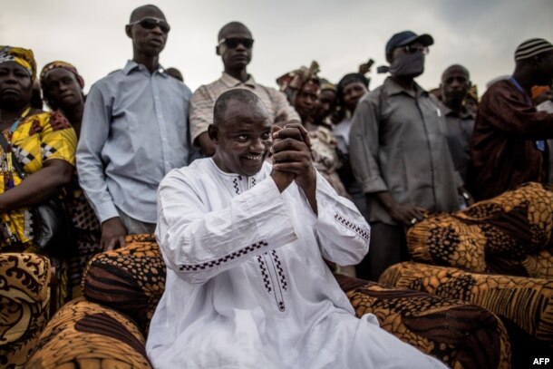 Adama Barrow, the flag-bearer of the coalition of the seven opposition political parties in Gambia, greets supporters during a gathering in the Buffer Zone district of Talinding, Nov. 29, 2016, on the last day of the presidential campaign in Gambia.