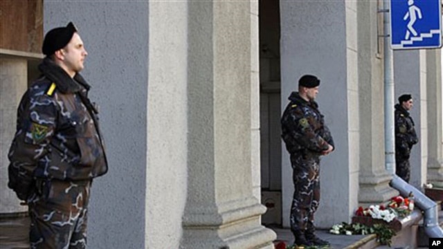 Special force officers guard an entrance to Minsk subway, after identifing suspects in Monday's bombing as the death toll rose to 12, with more than 200 wounded, April 12, 2011.
