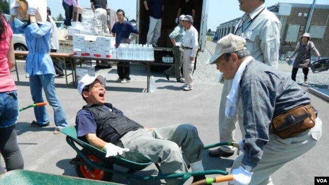 Volunteers deliver food and good cheer at a temporary housing complex in Japan. (Kate O'Berg)