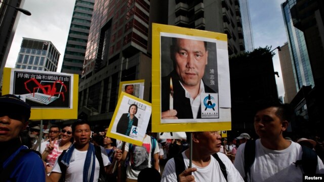 香港人在七一游行中举着浦志强和高瑜的像片（2014年7月1日）