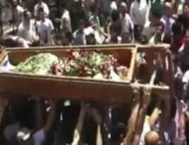 Mourners carry the body of a person during a funeral ceremony in the city of Homs, Syria, in this image made from amateur video released by Ugarit News, August 2, 2011