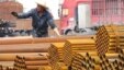 An employee unloads steel products at a market in Yichang, Hubei Province, China, April 11, 2016. The European Commission is conducting three anti-dumping investigations and ‘will undertake other measures if necessary,’ its president said.