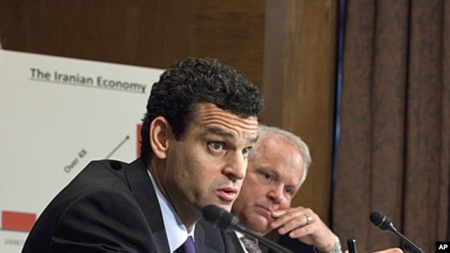 Treasury Undersecretary David Cohen, left, accompanied by Commerce Undersecretary David Mills, testifies on Capitol Hill in Washington, October 13, 2011.