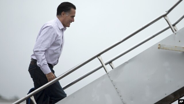 Republican presidential candidate Mitt Romney boards his campaign plane, October 9, 2012, in Newport News, Virginia.
