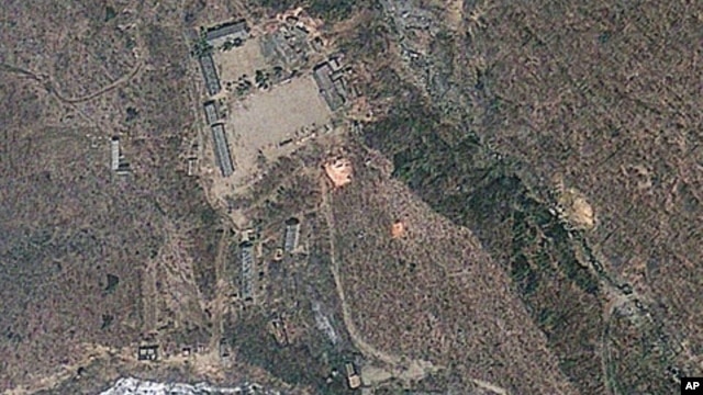 Satellite image provided by GeoEye appears to show a train of mining carts, at the lower center of the frame, and other preparations underway at North Korea's Punggye-ri nuclear test site, April 18, 2012.