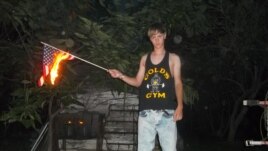 This undated photo taken from Lastrhodesian.com on June 20, 2015, allegedly shows Dylann Roof burning a U.S. flag. The site is no longer in operation.