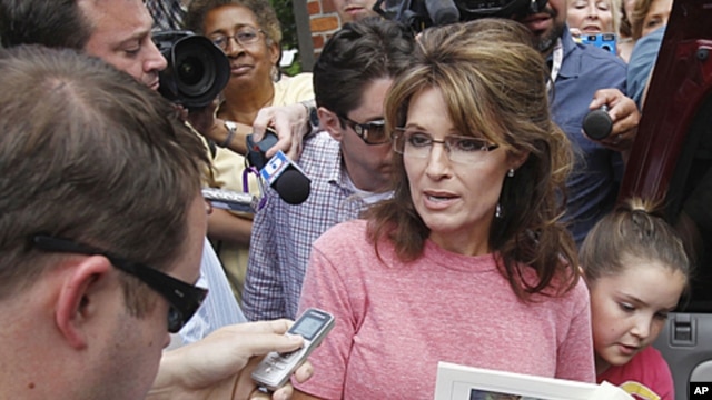 Former Alaska Governor Sarah Palin, holding a booklet depicting Paul Revere, speaks briefly with the media as she tours Boston's North End neighborhood, June 2, 2011 (file photo).