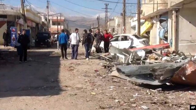 In this photo released by the Syrian official news agency SANA, a damaged area is seen after a car bomb explosion in Qatana, southwest of Damascus, Syria, Dec. 13, 2012.