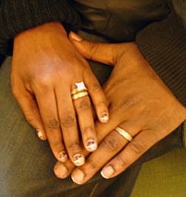 Hasson and Nicole show off their wedding rings.