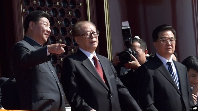 在“纪念中国人民抗日战争暨世界反法西斯战争胜利70周年”阅兵时,中国主席习近平和前主席江泽民交谈。胡锦涛在旁边(2015年9月3日)