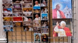 Postcards and calendars are displayed outside a shop at the Vatican, February 12, 2013.