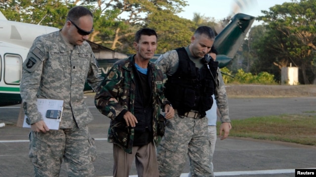 U.S. military servicemen assist freed Australian national Warren Richard Rodwell after he gets off a helicopter inside a military camp in Zamboanga City, southern Philippines, March 23, 2013, in this picture provided by the Western Mindanao Command of the