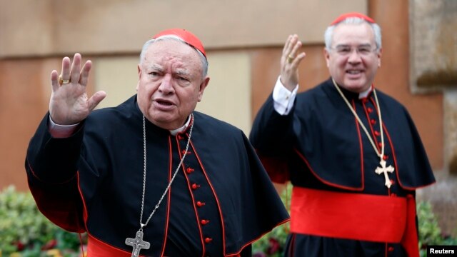 Mexican Cardinals Juan Sandoval Iniguez (L) and Josz Francisco Robles Ortega (R) wave as they arrive at a meeting at the Synod Hall in the Vatican March 7, 2013.