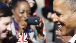 U.S. President Barack Obama smiles as he greets onlookers upon arriving at Newport News/Williamsburg International Airport in Williamsburg, Virginia, October 13, 2012. 