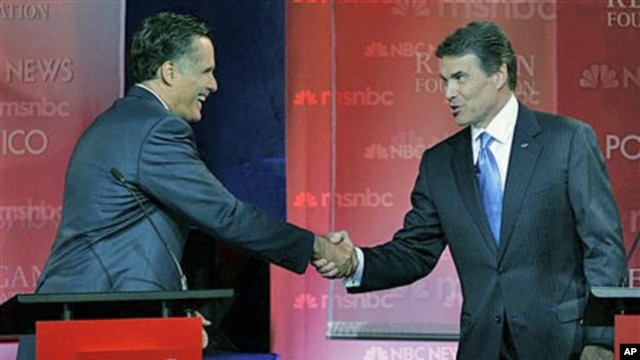 Republican presidential candidates former Massachusetts Governor Mitt Romney (L), and Texas Governor Rick Perry shake hands at the finish of a Republican presidential candidate debate at the Ronald Reagan Presidential Library in Simi Valley, California, S