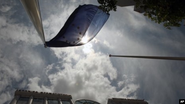 A European Union flag flies outside the stock exchange in Athens, Greece, May  2012.
