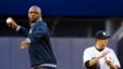 Patrick Vieira, left, head of the elite development squad at Manchester City Football Club, throws out the ceremonial first pitch near New York Yankees' Hiroki Kuroda, Yankee Stadium, New York, May 17, 2013.