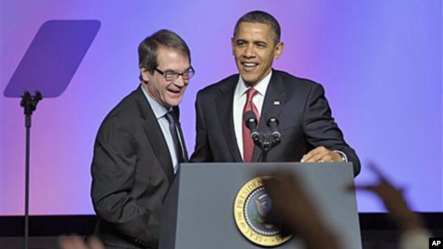 President Barack Obama talks with United Auto Workers [UAW] president Bob King after arriving to speak at the UAW conference in Washington, February 28, 2012.