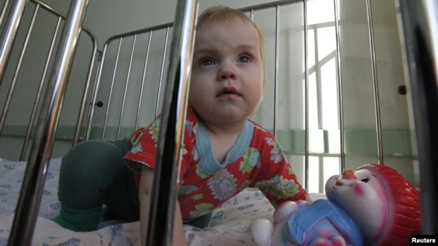 One-year-old Artur and his two-year-old brother Mark (not pictured) were brought to a local hospital in Russia's Siberian city of Krasnoyarskl by the police due to neglect by their parents. They  are currently waiting to be put up for adoption, March 23, 2011.