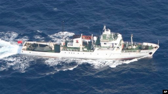 In this photo released by Japan Coast Guard, a Chinese fisheries patrol boat sails near disputed islands, called Senkaku in Japan and Diaoyu in China, in the East China Sea Tuesday, Sept. 18, 2012. 