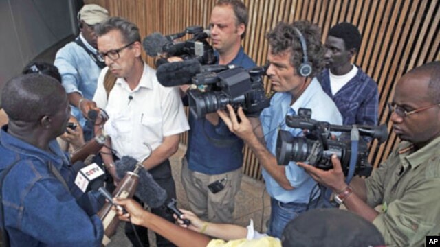 Members of the media surround war double-amputee Alhaji Jusu Jarka outside the Special Court for Sierra Leone, after a live broadcast of the verdict by a UN-backed court in the Hague convicting former Liberian president Charles Taylor of war crimes, in ca
