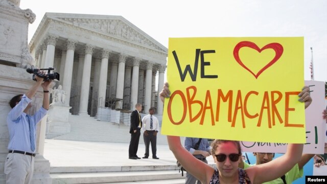 Supporters of the Affordable Care Act gather in front of the Supreme Court before the court's announcement of the legality of the law in Washington on June 28