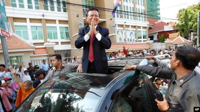 FILE - Cambodia's main opposition Cambodia National Rescue Party Deputy President and National Assembly Deputy President Kem Sokha greets to his supporters outside the Phnom Penh Municipality Court in Phnom Penh, Wednesday, April 8, 2015.