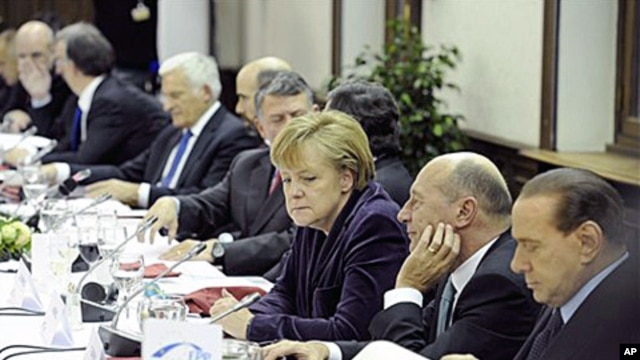 German Chancellor Angela Merkel, center, attends a round table during an EPP party meeting ahead of an EU summit in Brussels, 16 Dec 2010